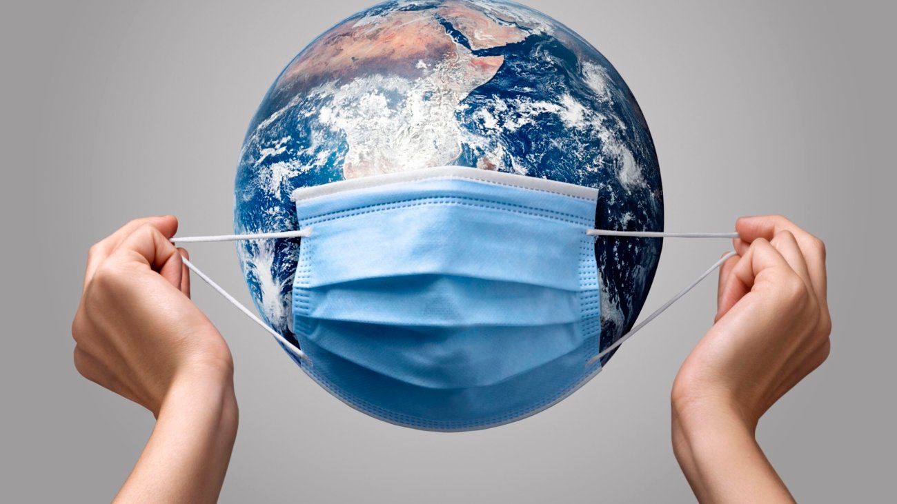 person-putting-medical-mask-earth