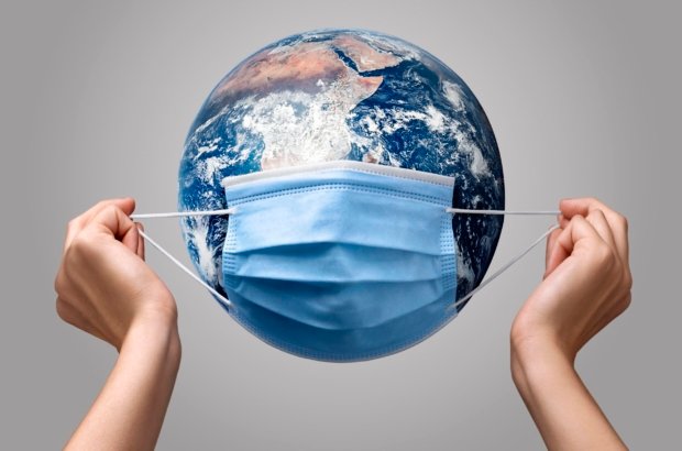 person-putting-medical-mask-earth